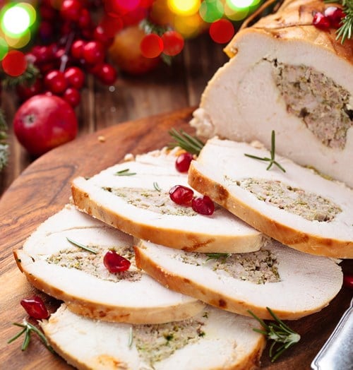 Slices of roasted, stuffed turkey with cranberries